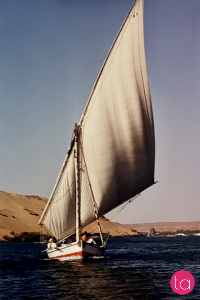 Traditional wooden sailing boat called felucca on the Nile River in Aswan, Egypt