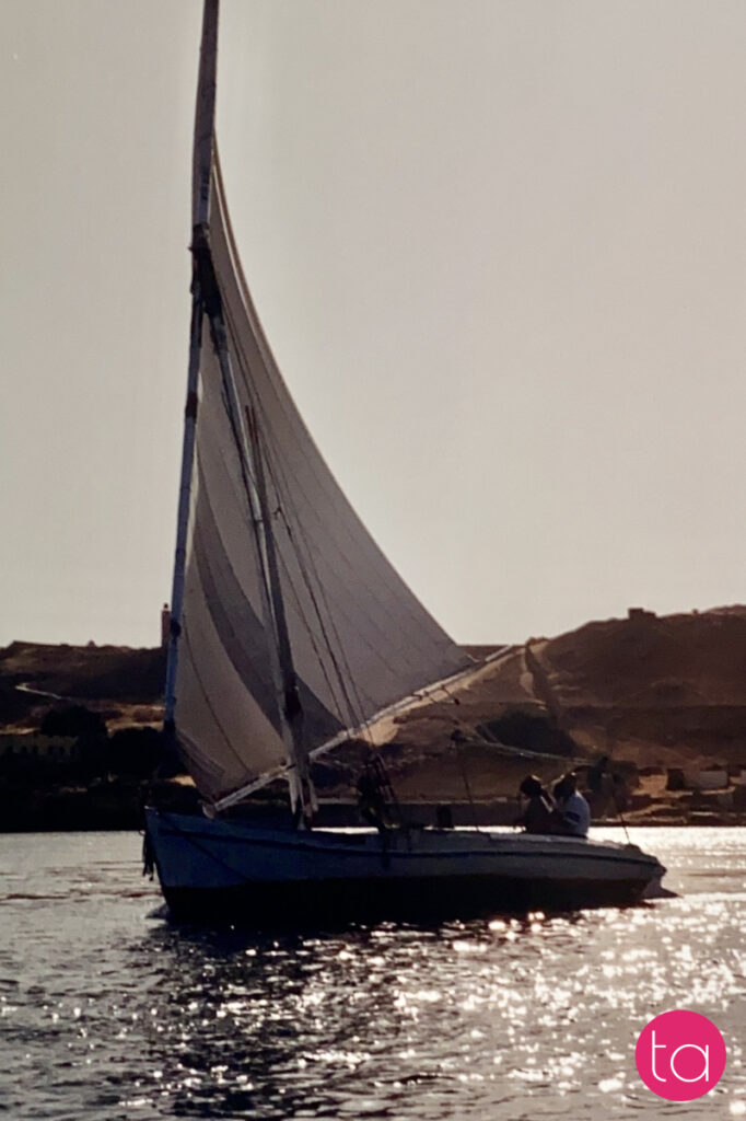 Traditional wooden sailing boat called felucca on the Nile River in Aswan, Egypt