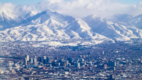 aerial view of a city by the snowy mountains