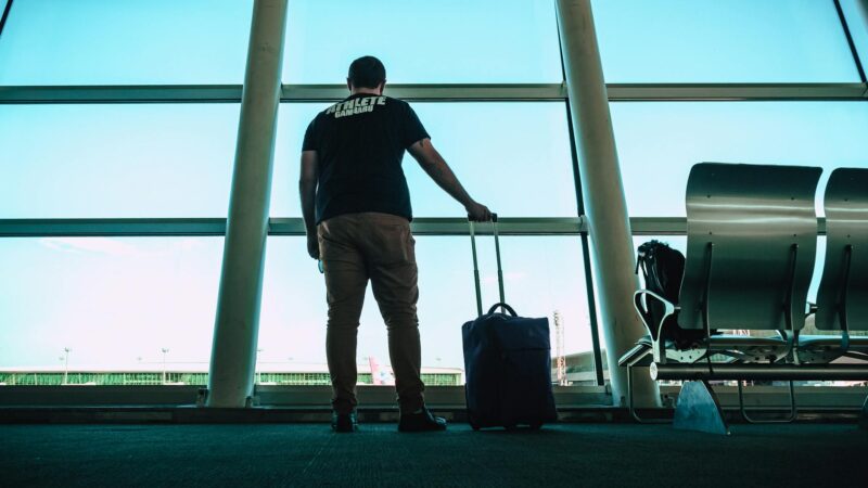 man holding luggage bag