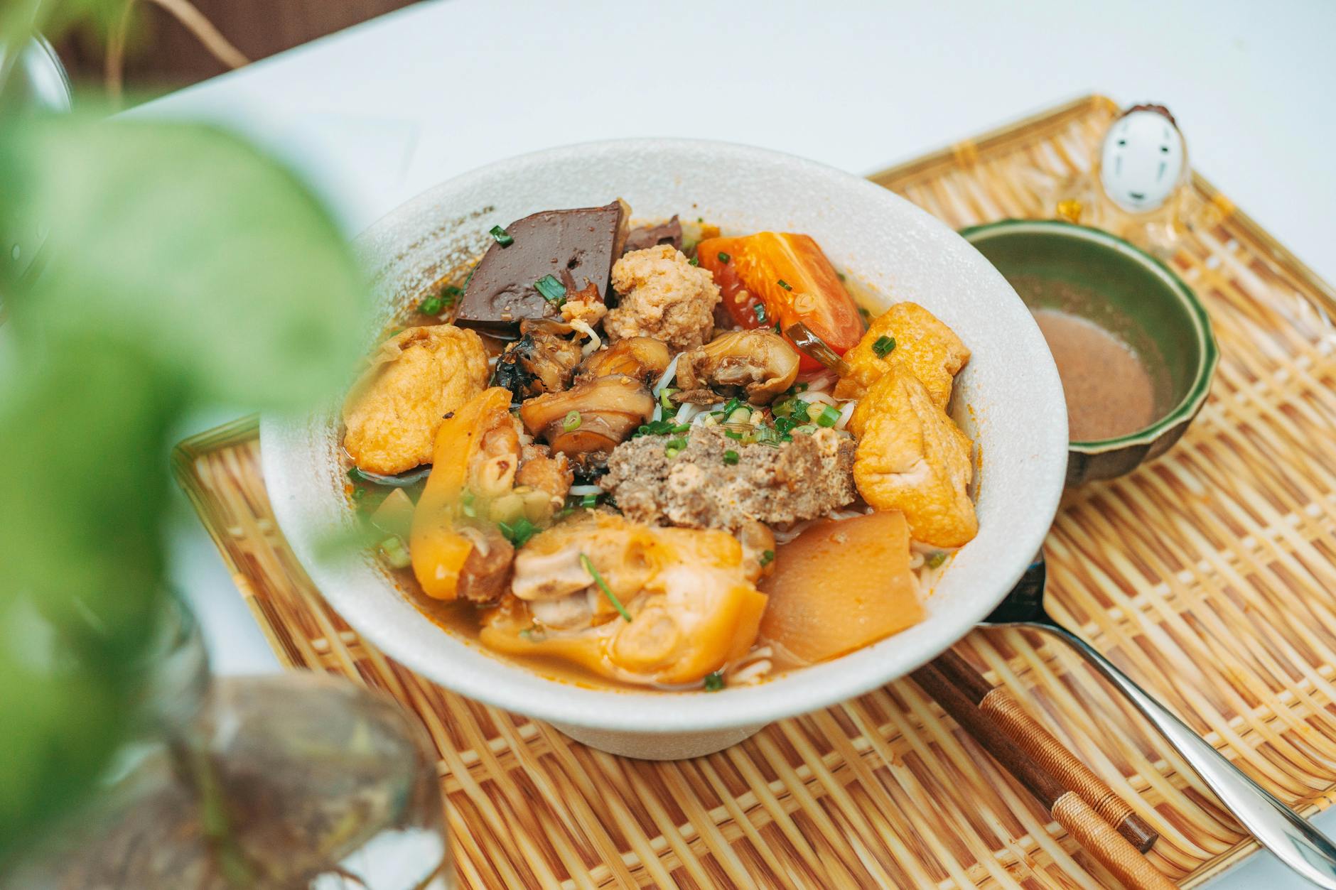 a bowl of food with meat and vegetables on a plate