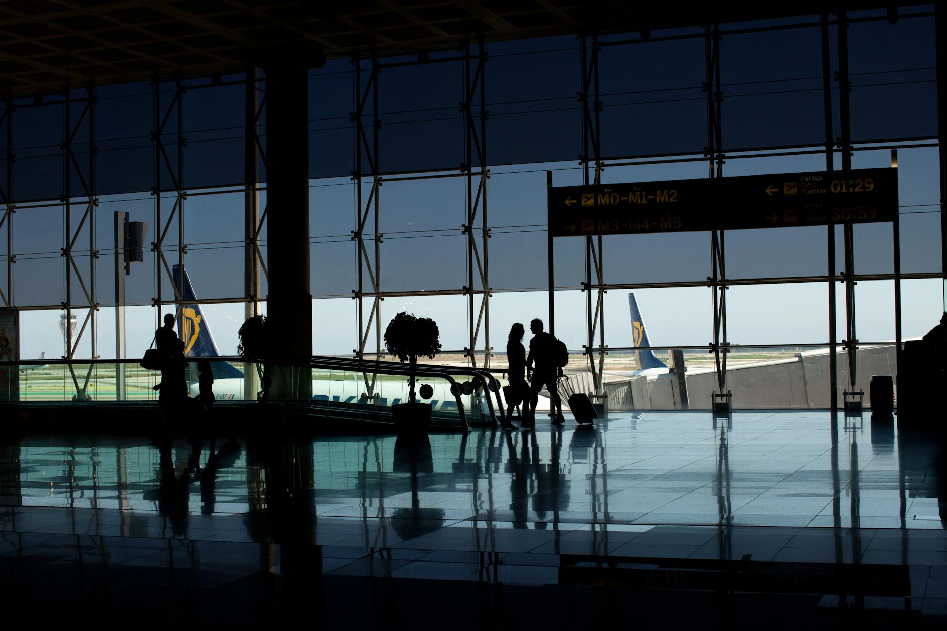 silhouette of people walking at the airport
