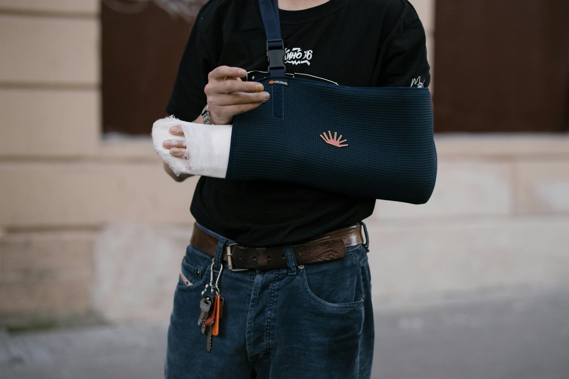 person with blue bandage on his injured arm