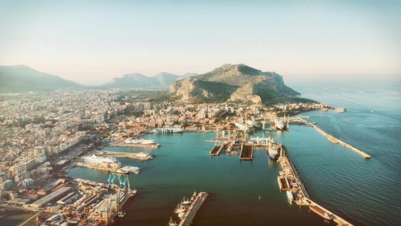 aerial photography of city beside mountain