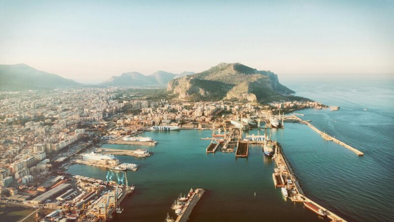 aerial photography of city beside mountain