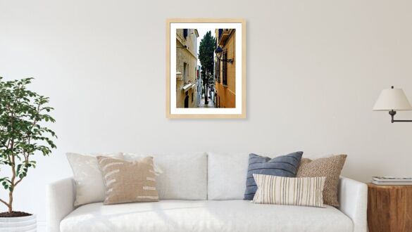 A Tree-Lined Alleyway in the Charming Streets of Sitges, Spain Framed Print