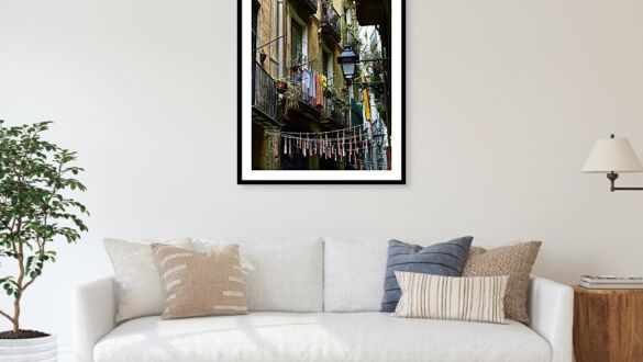 Daily Life on a Barcelona Balcony with Colorful Clotheslines Framed Print