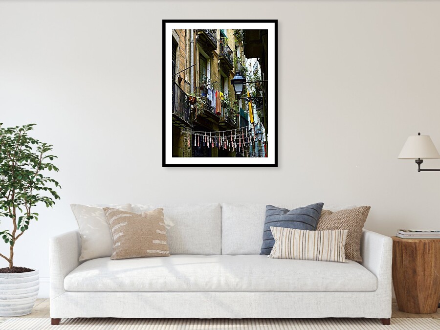 Daily Life on a Barcelona Balcony with Colorful Clotheslines Framed Print