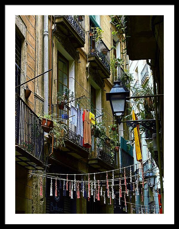 Daily Life on a Barcelona Balcony with Colorful Clotheslines Framed Print