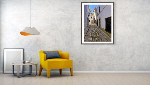 Sun-Drenched Cobblestone Alleyway in Sitges, Spain Framed Print