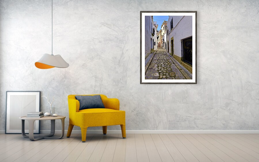 Sun-Drenched Cobblestone Alleyway in Sitges, Spain Framed Print