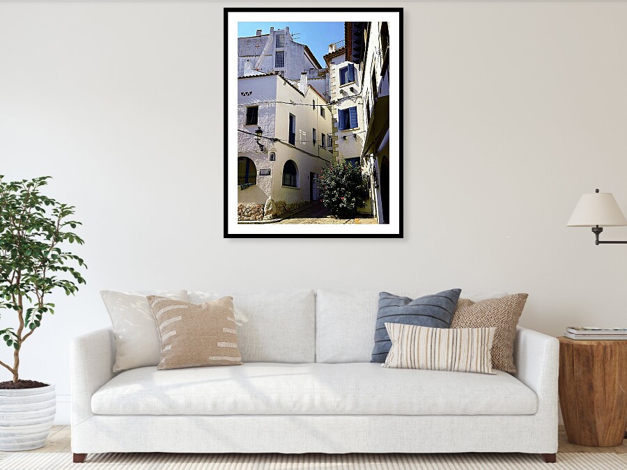 Whitewashed Street with Blue Shutters in Sitges, Spain Framed Print