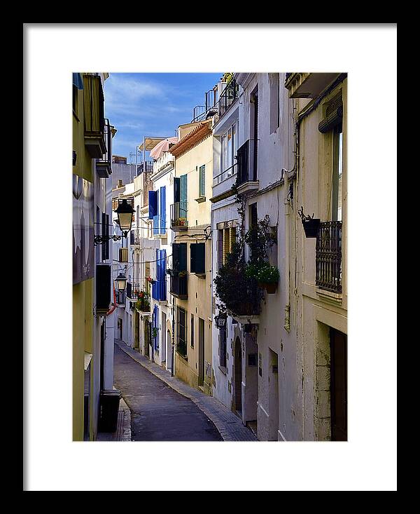 Long White-Walled Alley with Blue Shutters, Sitges Old Town Framed Print
